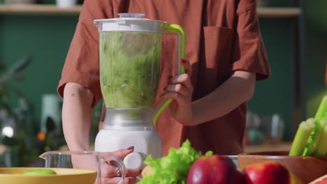 Woman-Making-Green-Smoothie-in-Blender-at-Home